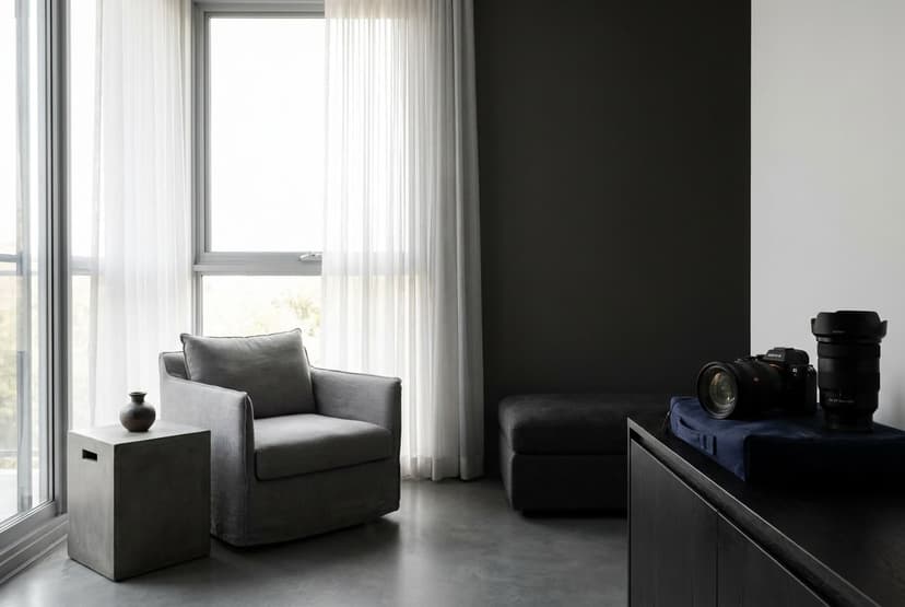 A high-contrast interior photograph balanced so that both a bright sunlit window and the shadowed room around it hold full detail, white curtains glowing without blowing out and dark corners still showing texture