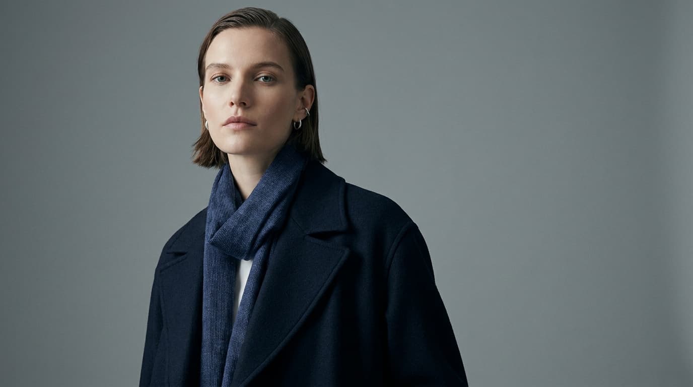 A styled editorial fashion portrait against a clean backdrop