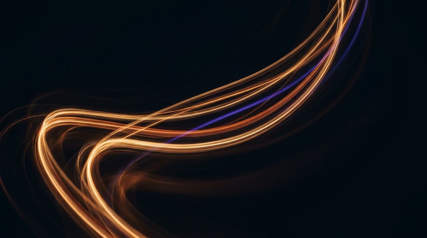 Glowing light trails traced through the dark in a long exposure