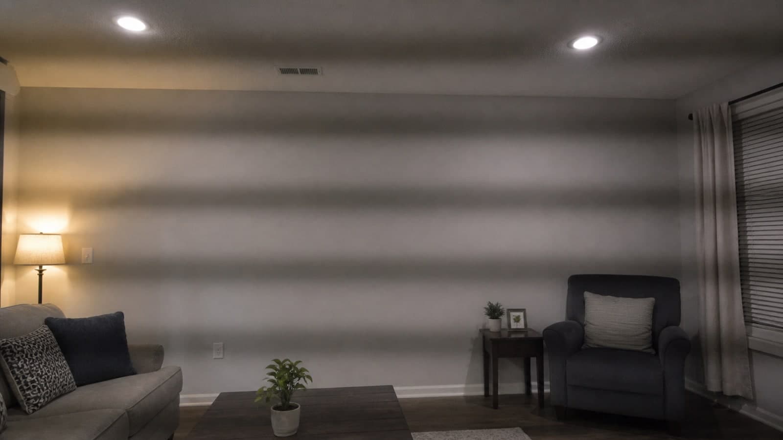 An indoor video frame with broad horizontal brightness bands caused by flickering LED room lights