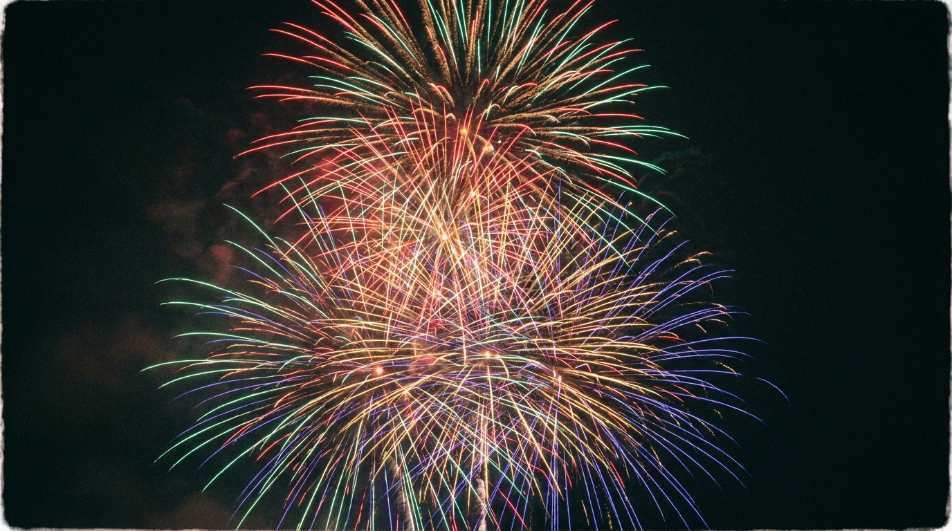A dense, layered night sky packed with several firework bursts of red, gold, blue, and violet overlapping at different heights, all collected into one full, vibrant frame